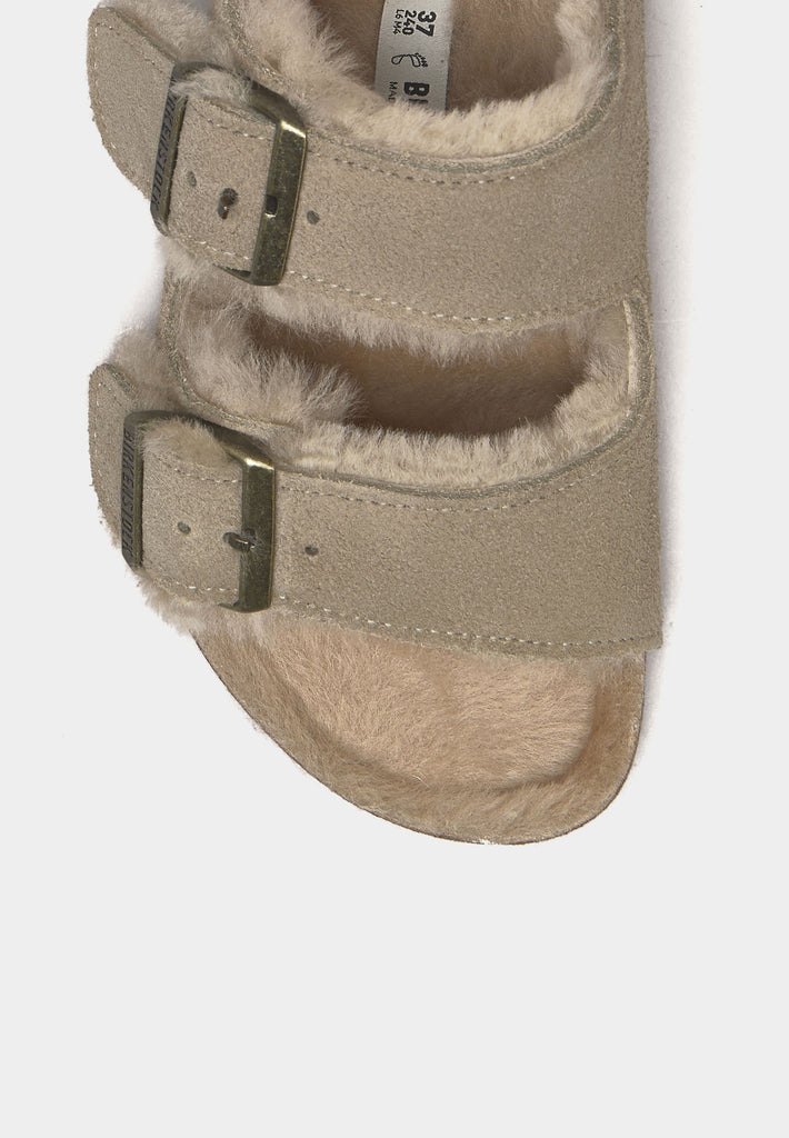 Close-up of Birkenstock Arizona Shearling Taupe showing suede texture and metal buckles.