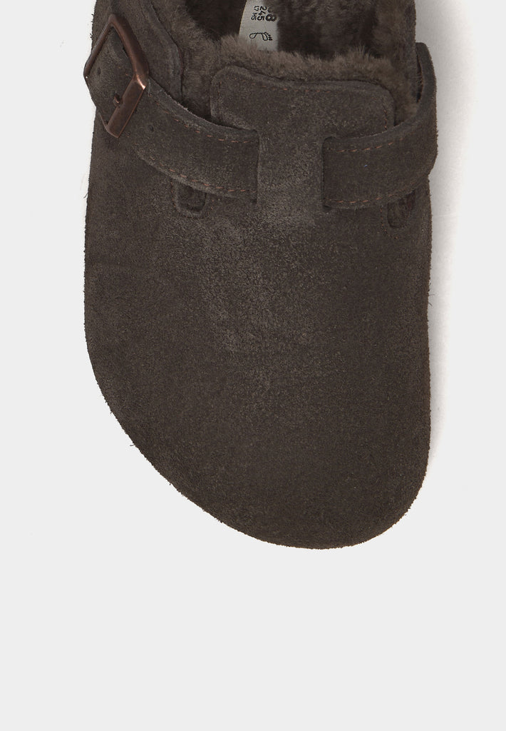Close-up of Birkenstock Boston Shearling clog showing mocca suede texture and buckle strap.